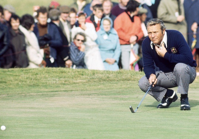 Arnold Palmer of the USA lines up a putt