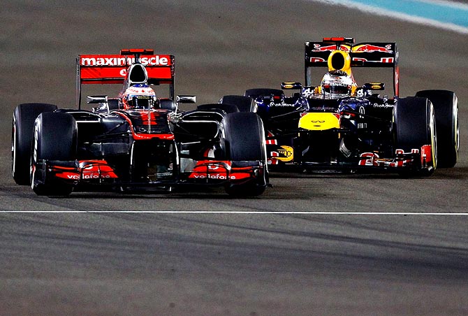 Red Bull's Sebastian Vettel (right) tries to overtake Jenson Button of McLaren