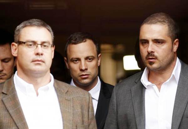 Oscar Pistorius (centre) leaves after his trial at the North Gauteng high court in Pretoria on April 9