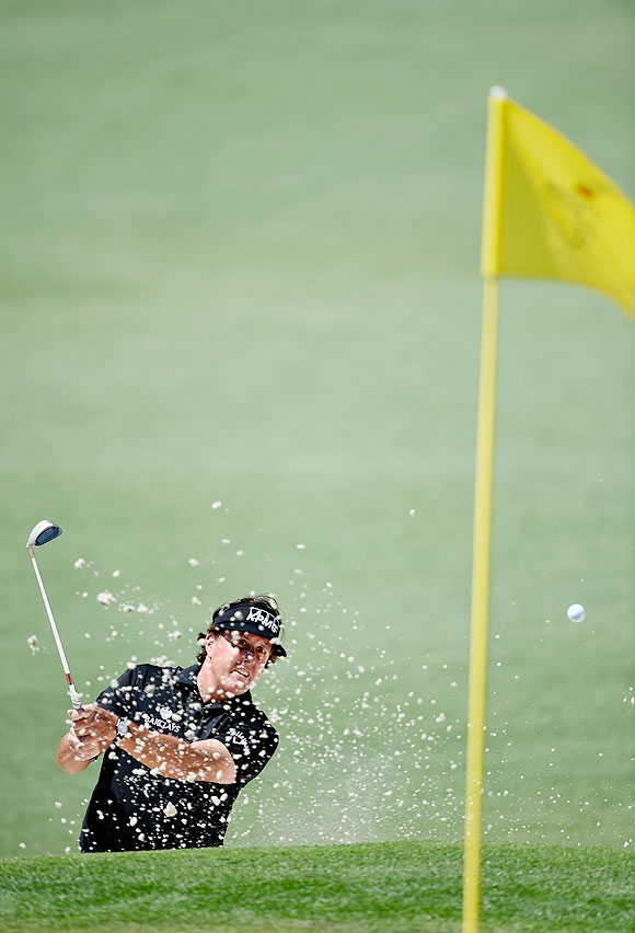 Phil Mickelson of the United States plays a bunker shot on the second hole during the first round of the 2014 Masters Tournament at Augusta National Golf Club on Thursday