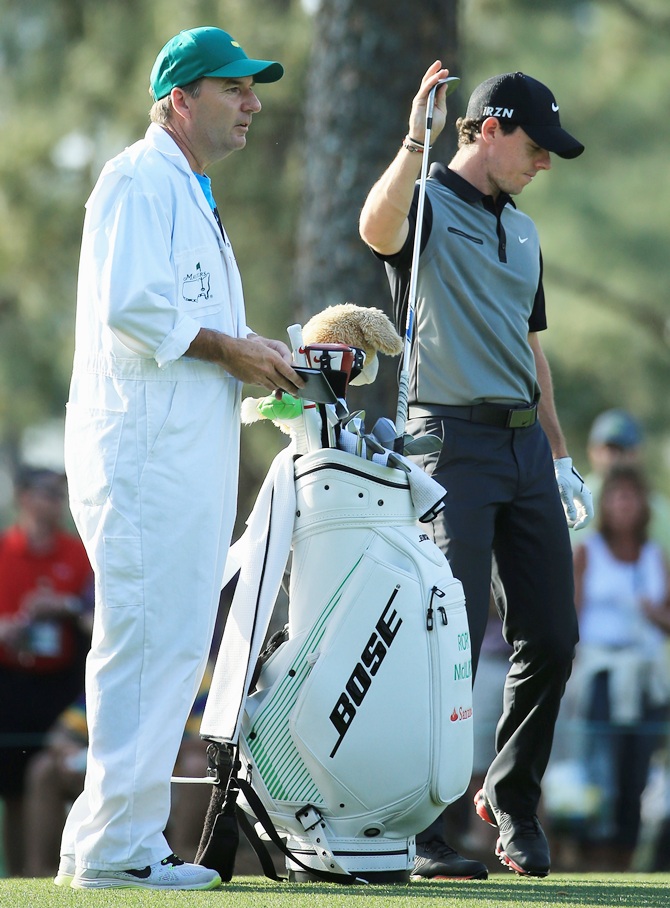 Rory McIlroy of Northern Ireland get a club from his caddie JP Fitzgerald
