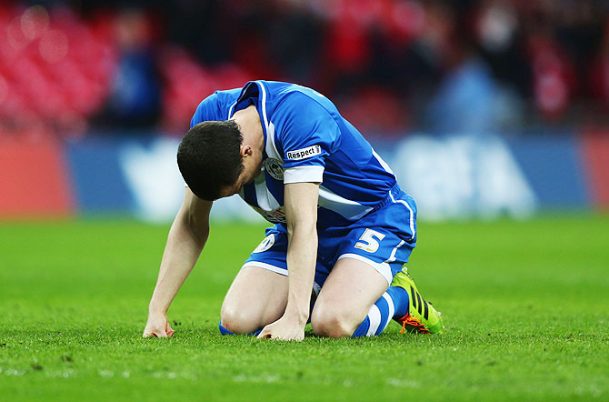 Gary Caldwell of Wigan Athletic reacts after missing a penalty in the shootout on Saturday