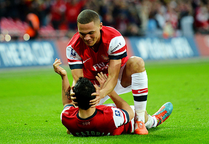 Arsenal Kieran Gibbs congratulates teammate Santi Cazorla on scoring the winning penalty on Saturday