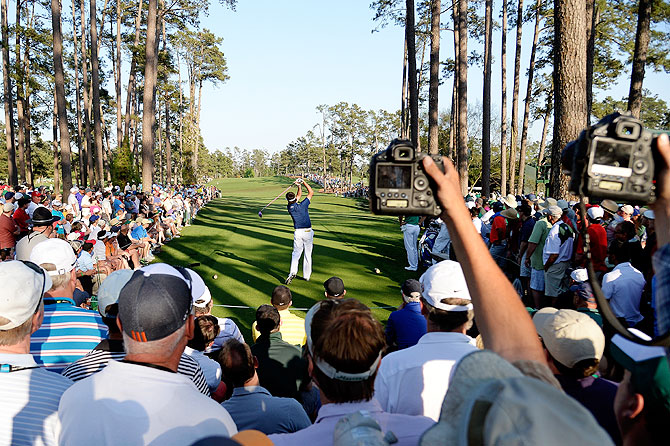 Fans capture pictures as Bubba Watson of the United States hits his tee shot on the 17th hole on Saturday