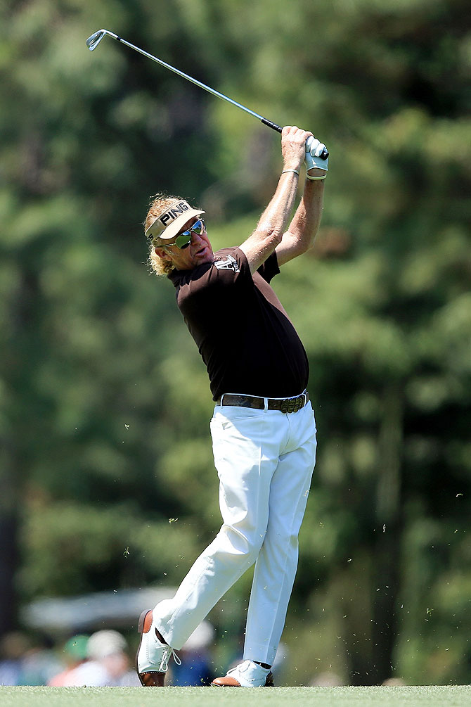 Miguel Angel Jimenez of Spain watches his approach shot on the 14th fairway on Saturday