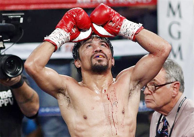 Manny Pacquiao of the Philippines celebrates his unanimous decision victory over WBO welterweight champion Timothy Bradley of the U.S. on Saturday