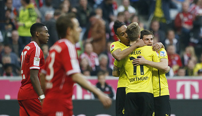 Borussia Dortmund's Pierre-Emerick Aubameyang (3rd from left) Marco Reus (2nd from right) and Jonas Hofmann (right) celebrate a goal against Bayaern Munich during their Bundesliga match in Munich on Saturday