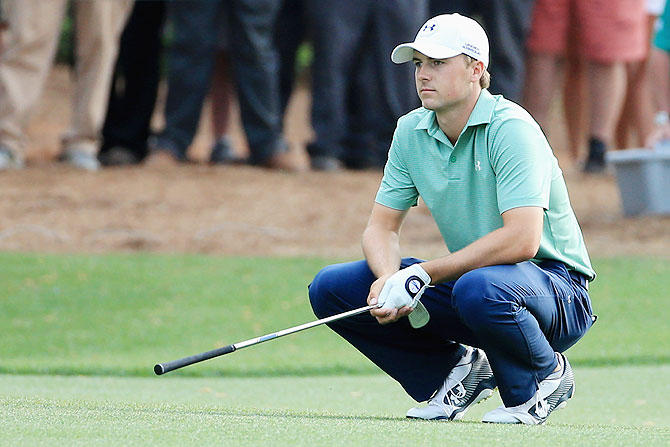 Jordan Spieth of the United States reacts to a poor shot on the 14th hole during the final round of the 2014 Masters Tournament at Augusta National Golf Club on Sunday