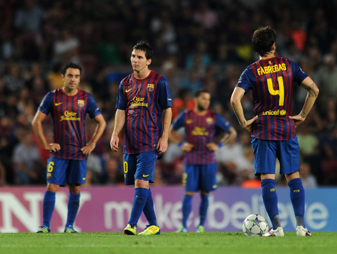 Lionel Messi and his Barcelona teammates stand dejected