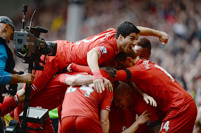 Liverpool players celebrate a goal by Philippe Courtinho (obscured) during their match against Manchester City during their English Premier League match at Anfield in Liverpool on Sunday