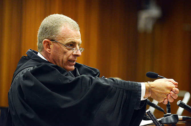 State prosecutor Gerrie Nel questions Oscar Pistorius during cross examination in Pretoria High Court on Monday