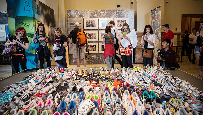Runner's shoes are laid out in a display titled, 'Dear Boston: Messages from the Marathon Memorial' in the Boston Public Library to commemorate the 2013 Boston Maraton bombings, on Tuesday