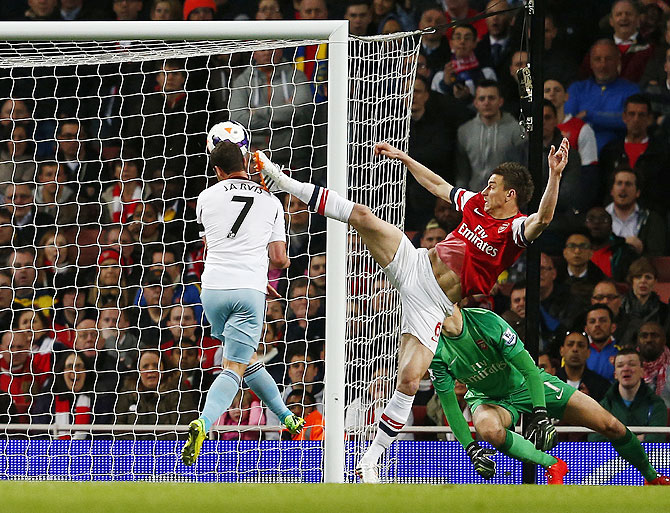 West Ham United's Matthew Jarvis (left) scores as he is challenged by Arsenal's Laurent Koscielny on Tuesday