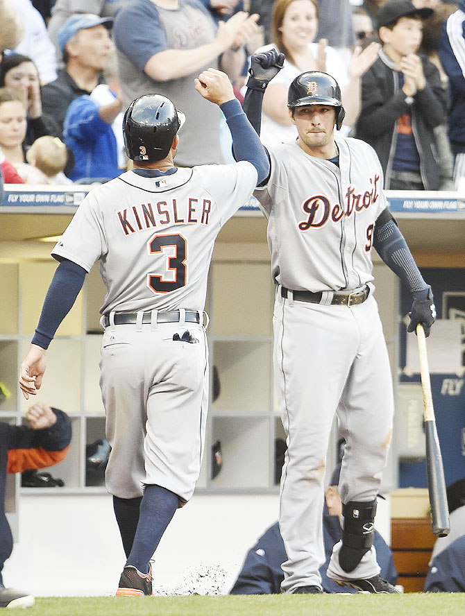 Ian Kinsler #3 of the Detroit Tigers is congratulated by Nick Castellanos #9 after scoring