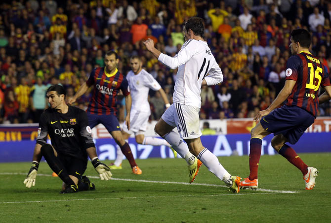 Real Madrid's Gareth Bale scores past Barcelona's goalkeeper Pinto during their King's Cup final at Mestalla stadium in Valencia on Wednesday
