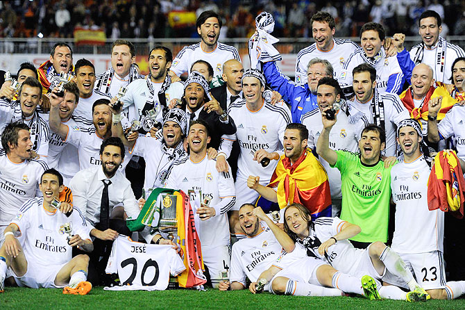Real Madrid CF players celebrate with the trophy after winning the Copa del Rey King's Cup final against FC Barcelona at Estadio Mestalla in Valencia on Wednesday