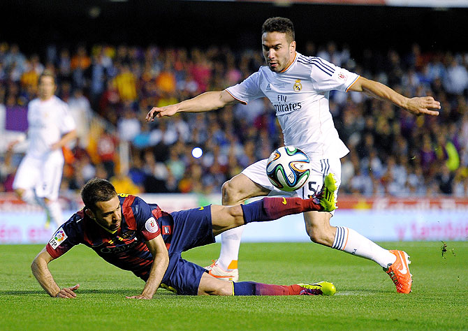 Jordi Alba (left) of Barcelona is tackled by Daniel Carvajal of Real Madrid on Wednesday