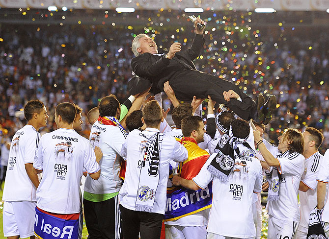 Real Madrid's manager Carlo Ancelotti is thrown into the air by his players after Real beat Barcelona to win the Copa del Rey final on Wednesday