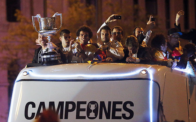 Real Madrid players celebrate winning the King's Cup on top of a bus as they arrive at Cibeles fountain in Madrid on Thursday 