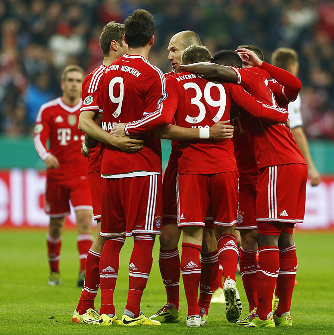 Bayern Munich's players celebrate after Tony Kroos scored a goal against 1.FC Kaiserslautern during their German soccer cup (DFB Pokal) semi-final match in Munich on Wednesday