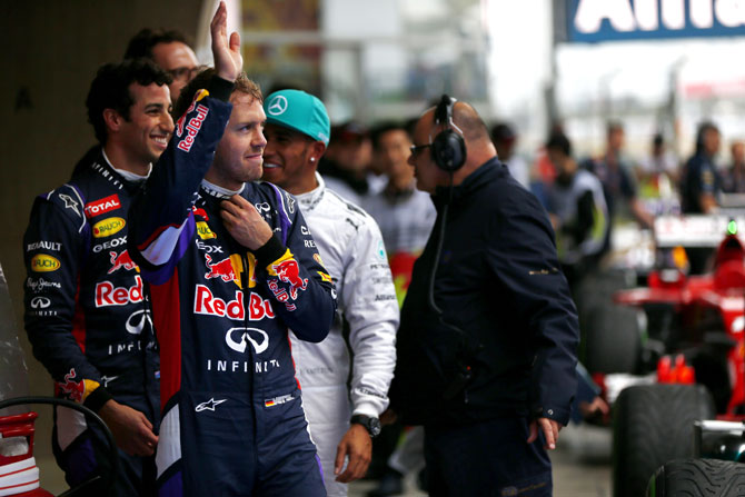 Sebastian Vettel of Germany and Infiniti Red Bull Racing waves to the fans