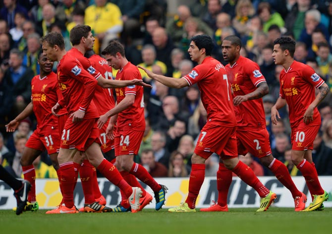 Liverpool players celebrate a goal during their match against Norwich City