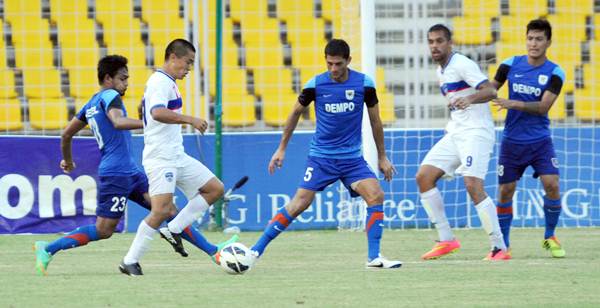 Sunil Chhetri tries to break through a host of Dempo defenders in Monday's I-League match