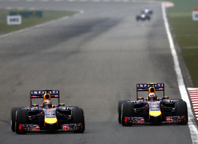 Sebastian Vettel (left) tries to pass Red Bull team mate Daniel Ricciardo 