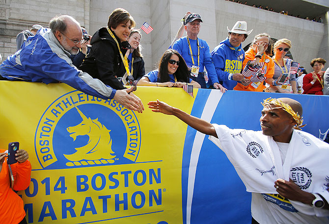 Meb Keflezighi of the U.S. (right) is congratulated after winning the men's division of the 118th Boston Marathon on Monday