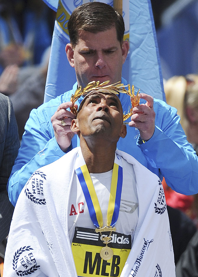 Meb Keflezighi of the U.S. receives the his garland after winning the men's division at the 118th Boston Marathon on Monday