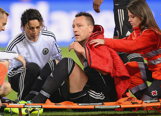 An injured John Terry of Chelsea receives treatment during the Champions League semi-final first leg match against Club Atletico de Madrid