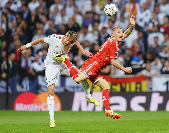 Bastian Schweinsteiger of Bayern Munich is challenged by Fabio Coentrao of Real Madrid during their Champions League semi-final first leg match on Wednesday