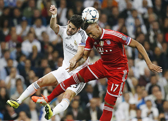 Real Madrid's Isco (left) challenges Bayern Munich's Jerome Boateng during their Champions League semi-final first leg match on Wednesday