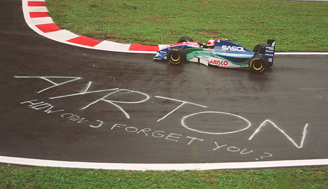 Rubens Barrichello of Brazil drives past a tribute to Ayrton Senna written on the tarmac during qualifying of the Belgian GP in 1994