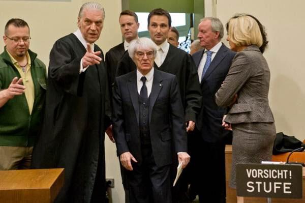 ernie Ecclestone (centre), the 83-year-old controlling business magnate in Formula One racing, and his lawyers Sven Thomas, Andreas Weitzell and Norbert Scharf arrive for the first day of his trial for bribery on Thursday