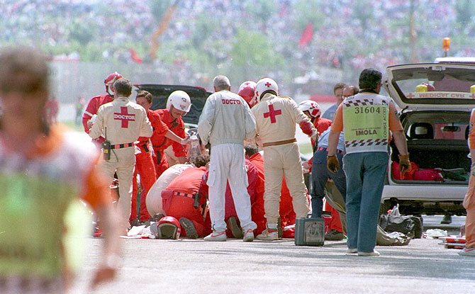 Ayrton Senna is attended to by medics on the track after he crashed into the concrete barrier with his Williams car during the early stages of the San Marino Grand Prix at Imola on May 1, 1994