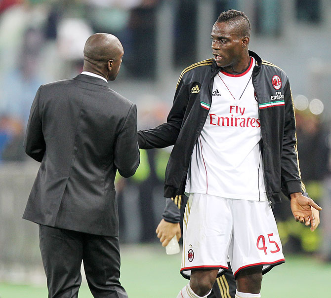 Mario Balotelli of AC Milan speaks with Clarence Seedorf during the Serie A match against AS Roma at Stadio Olimpico in Rome, Italy on Friday