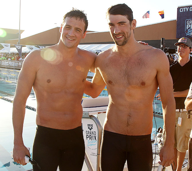 Ryan Lochte (left) and Michael Phelps (second place) pose together after finishing the Men's 100m Butterfly final 