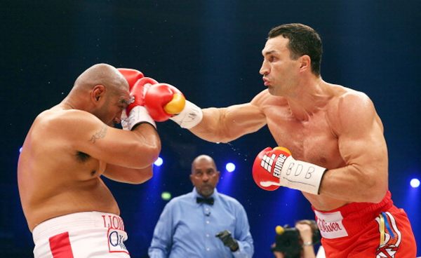 Wladimir Klitschko (right) of Ukraine exchanges punches with Alex Leapai of Australia during their WBO, WBA, IBF and IBO heavy weight title fight