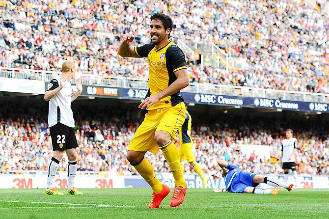 Atletico de Madrid's Raul Garcia celebrates after scoring the opening goal against Valencia during their La Liga match at Estadio Mestalla in Valencia on Sunday