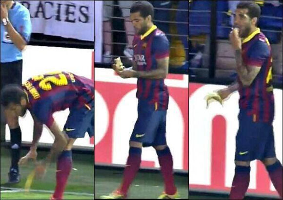 Barcelona's Dani Alves picks up and then eats the banana that was thrown at him during their match against Villareal on Sunday