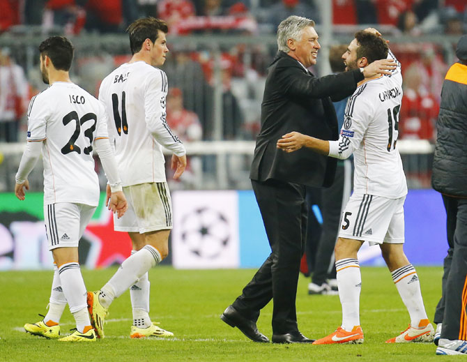 Real Madrid's coach Carlo Ancelotti (second right) celebrates with Daniel Carvajal (right) after defeating Bayern Munich