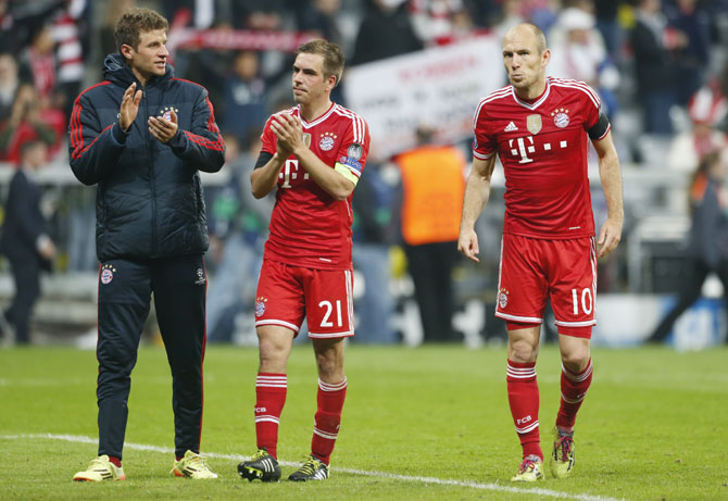 Bayern Munich's Thomas Mueller, Philipp Lahm and Arjen Robben (left to right) react after losing the Champion's League semi-final second leg