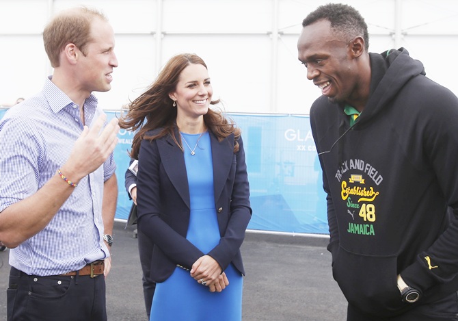 From left, Prince William, Duke of Cambridge and Catherine, Duchess of Cambridge meet   Usain Bolt during a visit to the Commonwealth Games Village