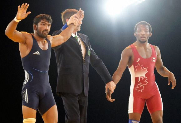 Yogeshwar Dutt of India celebrates after beating Jevon Balfour of Canada to win gold on Thursday