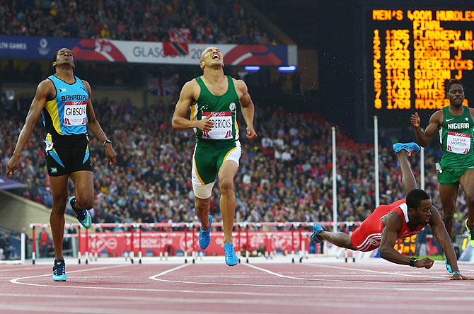 Cornel Fredericks of South Africa (centre) crosses the line ahead to win gold ahead of Jeffery Gibson of Bahamas and Jehue Gordon of Trinidad and Tobago in the Men's 400 metres hurdles final at Hampden Park on Thursday