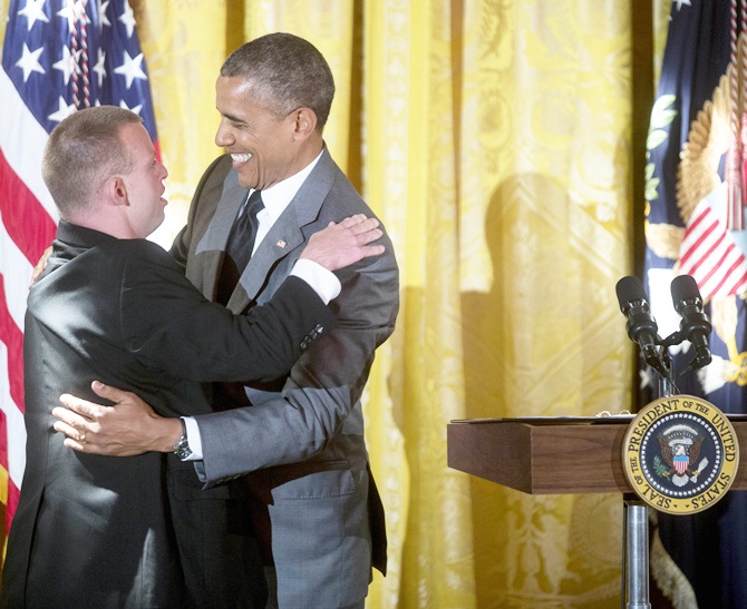 US President Barack Obama, right, embraces restaurateur Tim Johnson after Obama mentioned   him while speaking at an event titled 'A Celebration of Special Olympics and A Unified   Generation' to mark the anniversary of the Special Olympics in the East Room of the White House