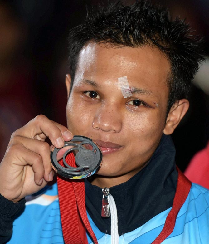 Devendro Singh Laishram of India poses with the silver medal