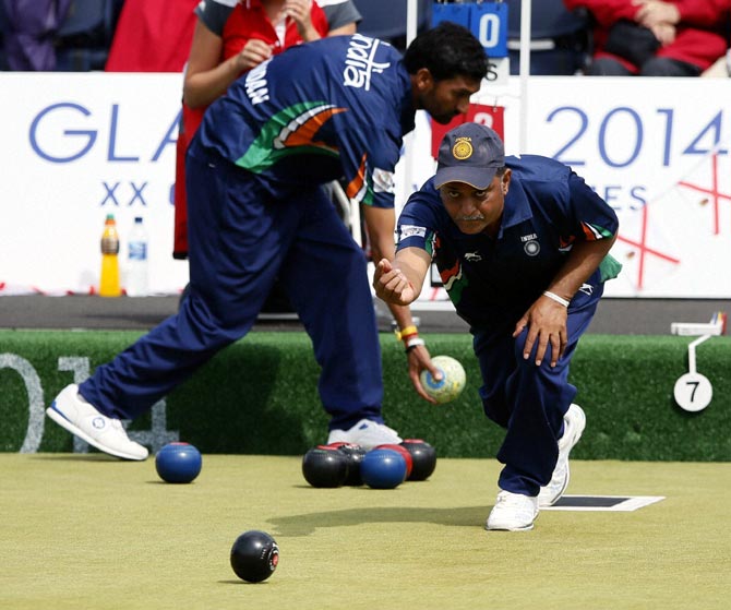 Dinesh Kumar of India bowls during the Lawn Bowls bronze medal match against Australia