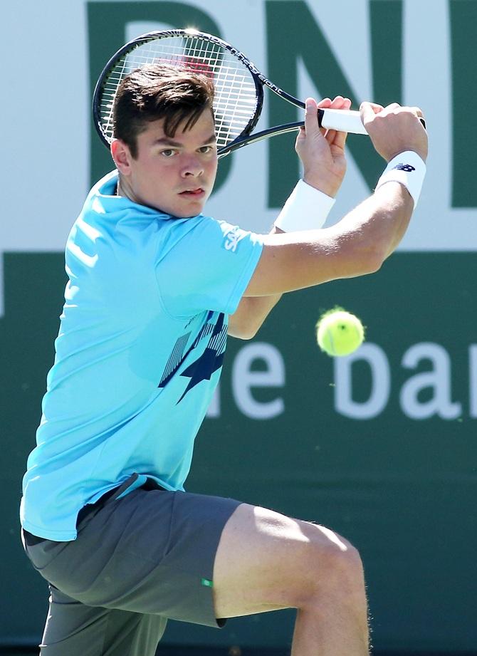 Milos Raonic of Canada hits a return